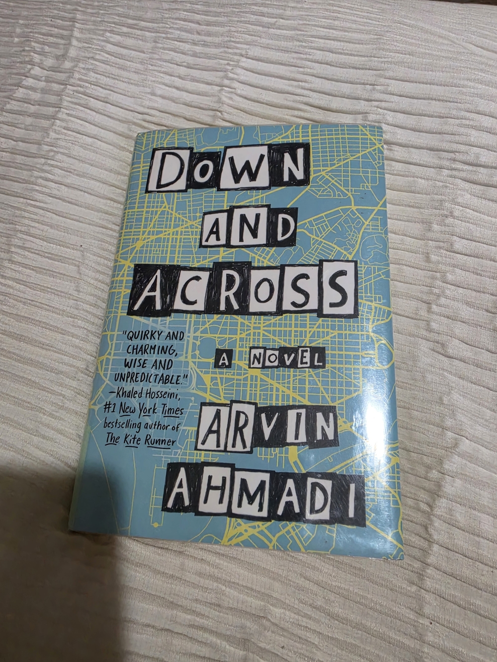 Down and Across by Arvin Ahmadi - Light Blue & Yellow Hardcover Novel